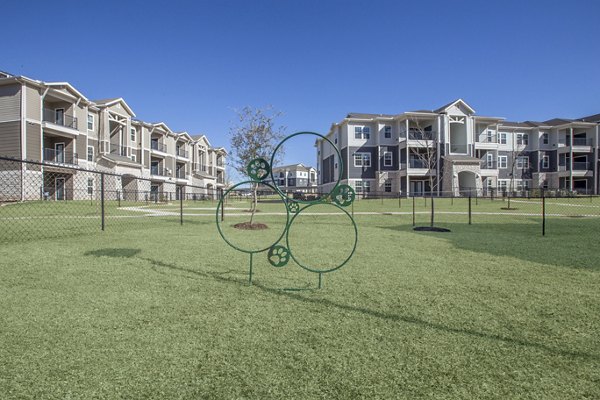 Spacious dog park at Roots at Waco Apartments, perfect for pet-friendly living