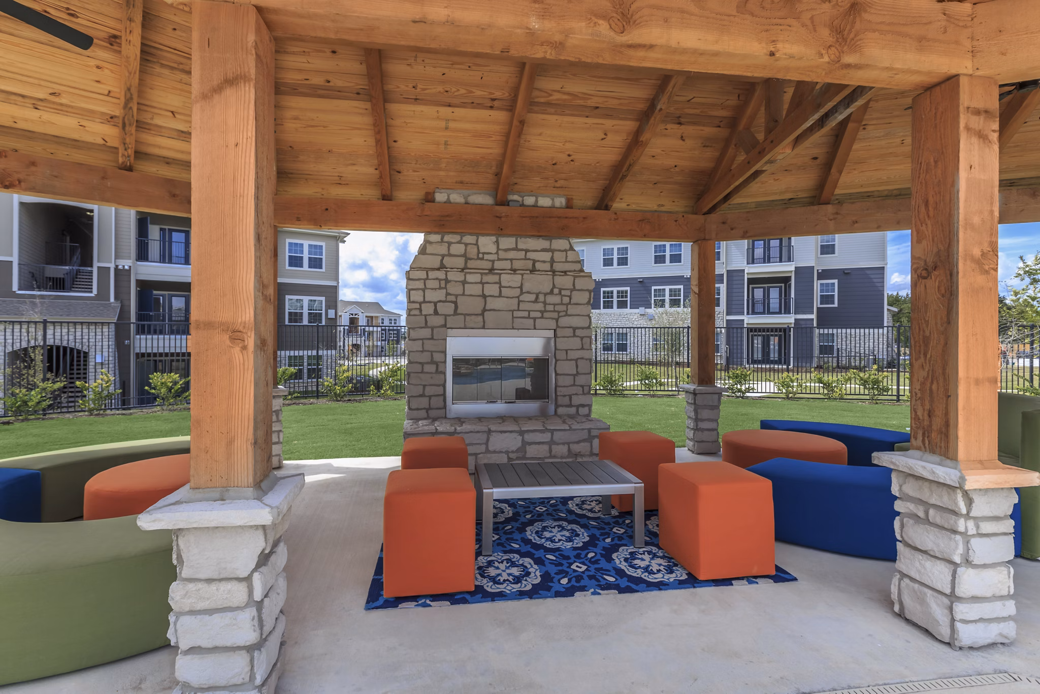 Cozy fire pit area at Roots at Waco Apartments, perfect for outdoor gatherings and relaxation evenings in the luxury setting