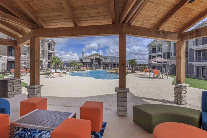 Outdoor fire pit surrounded by cozy seating at Roots at Waco Apartments, perfect for social gatherings and relaxation