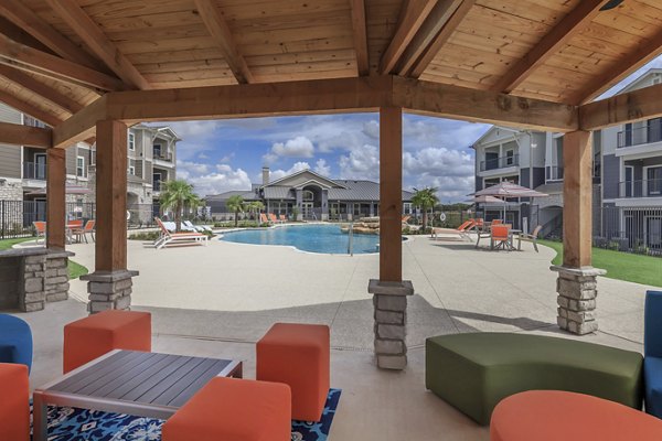 Outdoor fire pit surrounded by cozy seating at Roots at Waco Apartments, perfect for social gatherings and relaxation