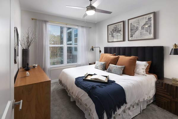 Bedroom featuring elegant decor and ample natural light at Overture Powers Ferry Apartments