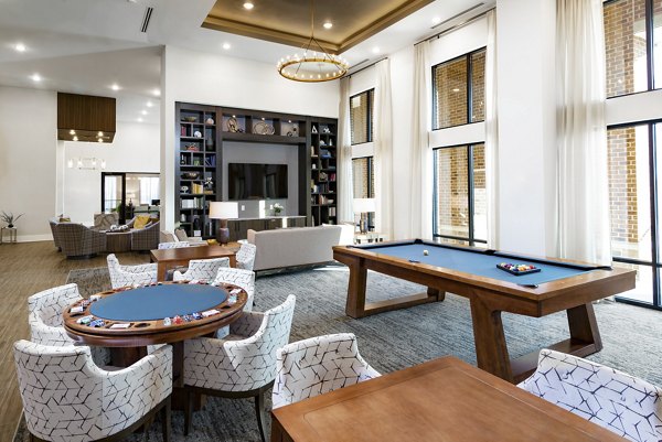 Game room with pool table and lounge seating at Overture Powers Ferry Apartments