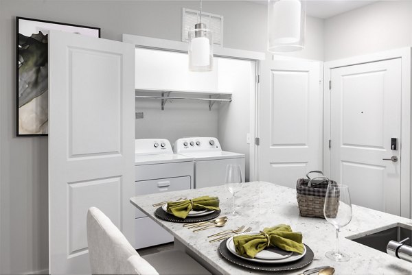 Modern laundry room with energy-efficient washers at Overture Powers Ferry Apartments