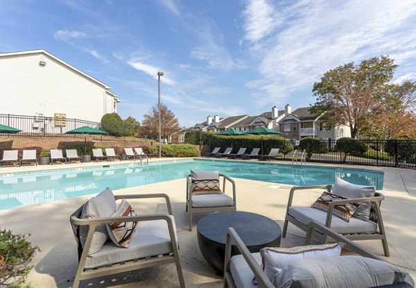 Resort-style pool with lounge seating at Avana Bellevue Apartments