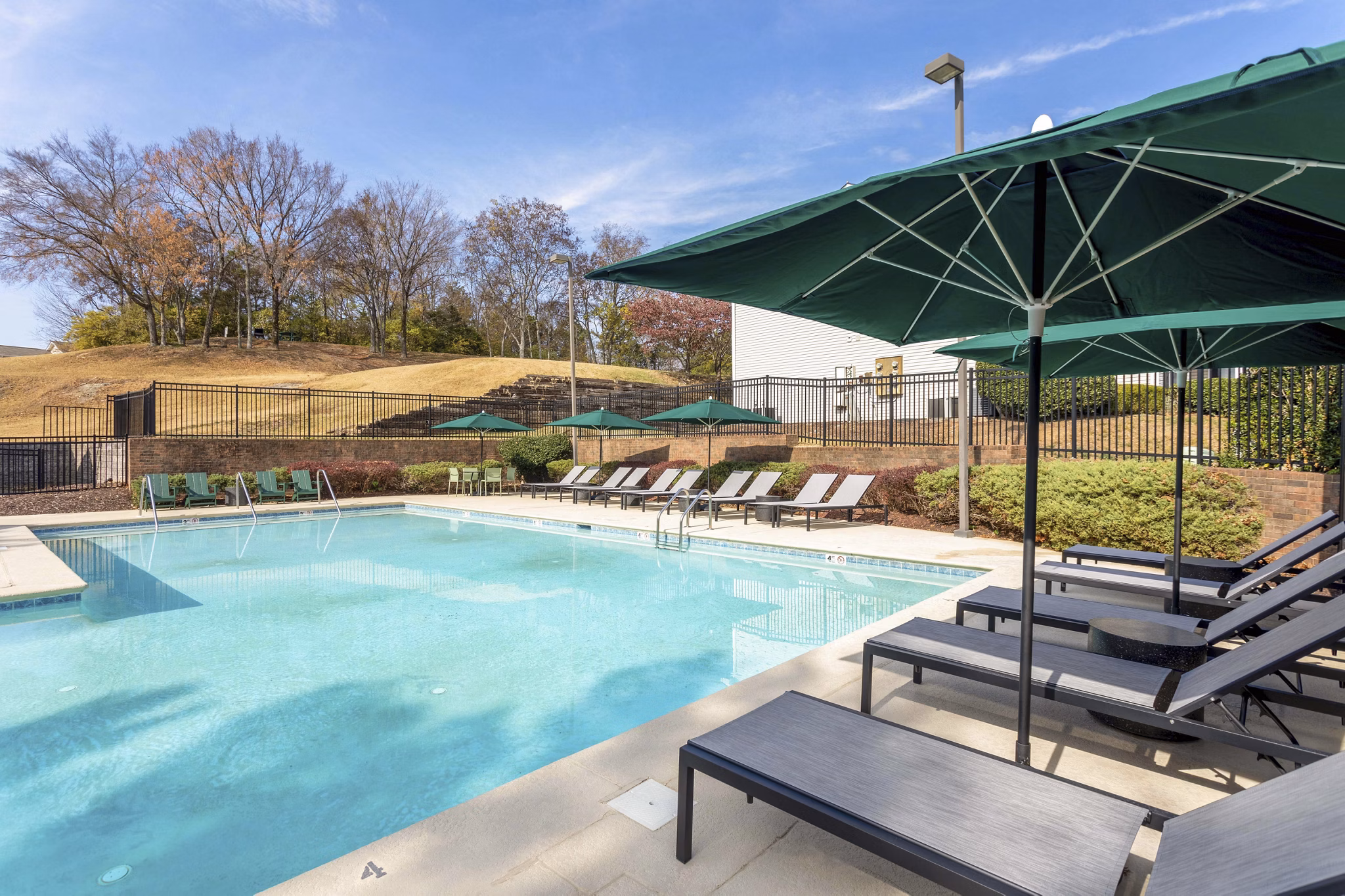 Luxurious pool area with modern lounge chairs at Avana Bellevue Apartments, offering a premium living experience
