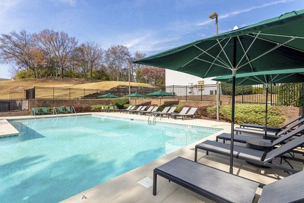 Luxurious pool area with modern lounge chairs at Avana Bellevue Apartments, offering a premium living experience