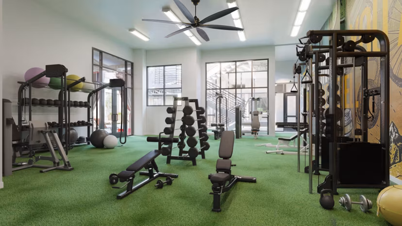 Fitness center with modern equipment at The Parlor Apartments, offering luxury living and wellness amenities for residents