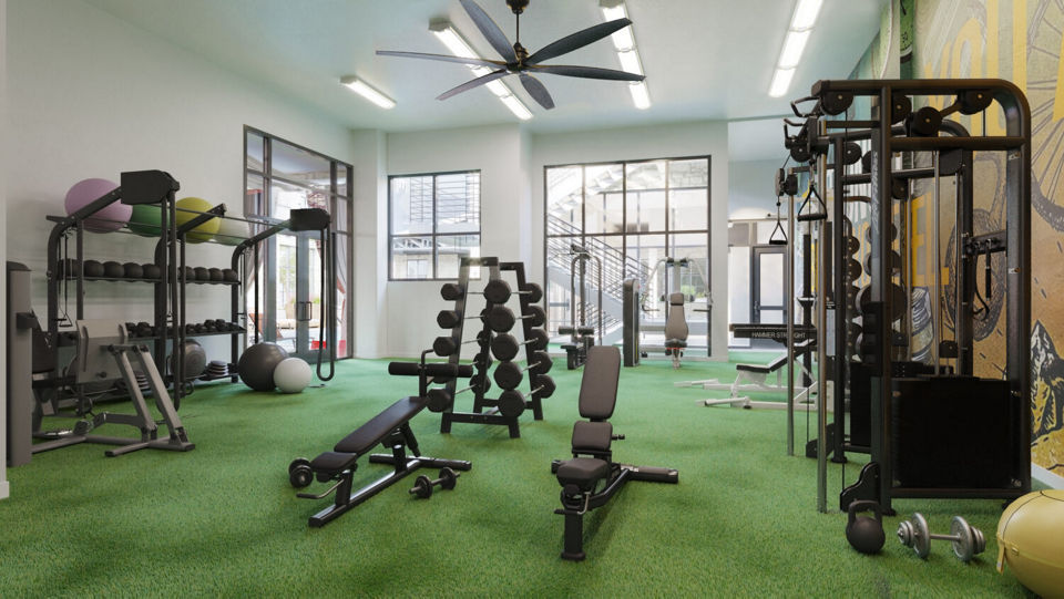 Fitness center with modern equipment at The Parlor Apartments, offering luxury living and wellness amenities for residents
