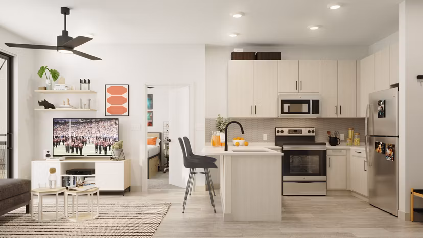 Modern kitchen featuring marble countertops and stainless steel appliances at The Parlor Apartments