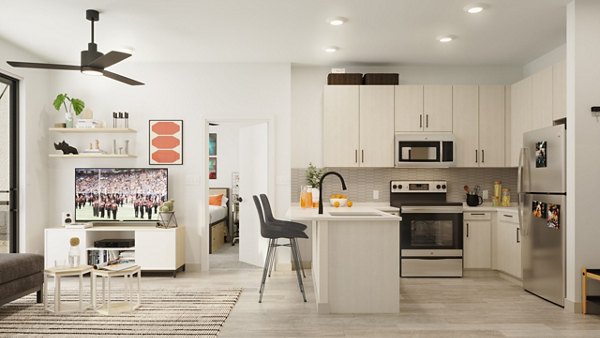 Modern kitchen featuring marble countertops and stainless steel appliances at The Parlor Apartments