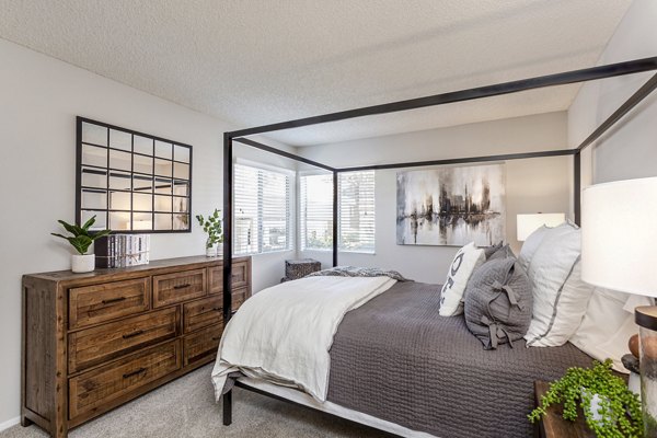 Bedroom with modern decor and large windows at Colony Parc Apartments, Greystar luxury community in San Luis Obispo