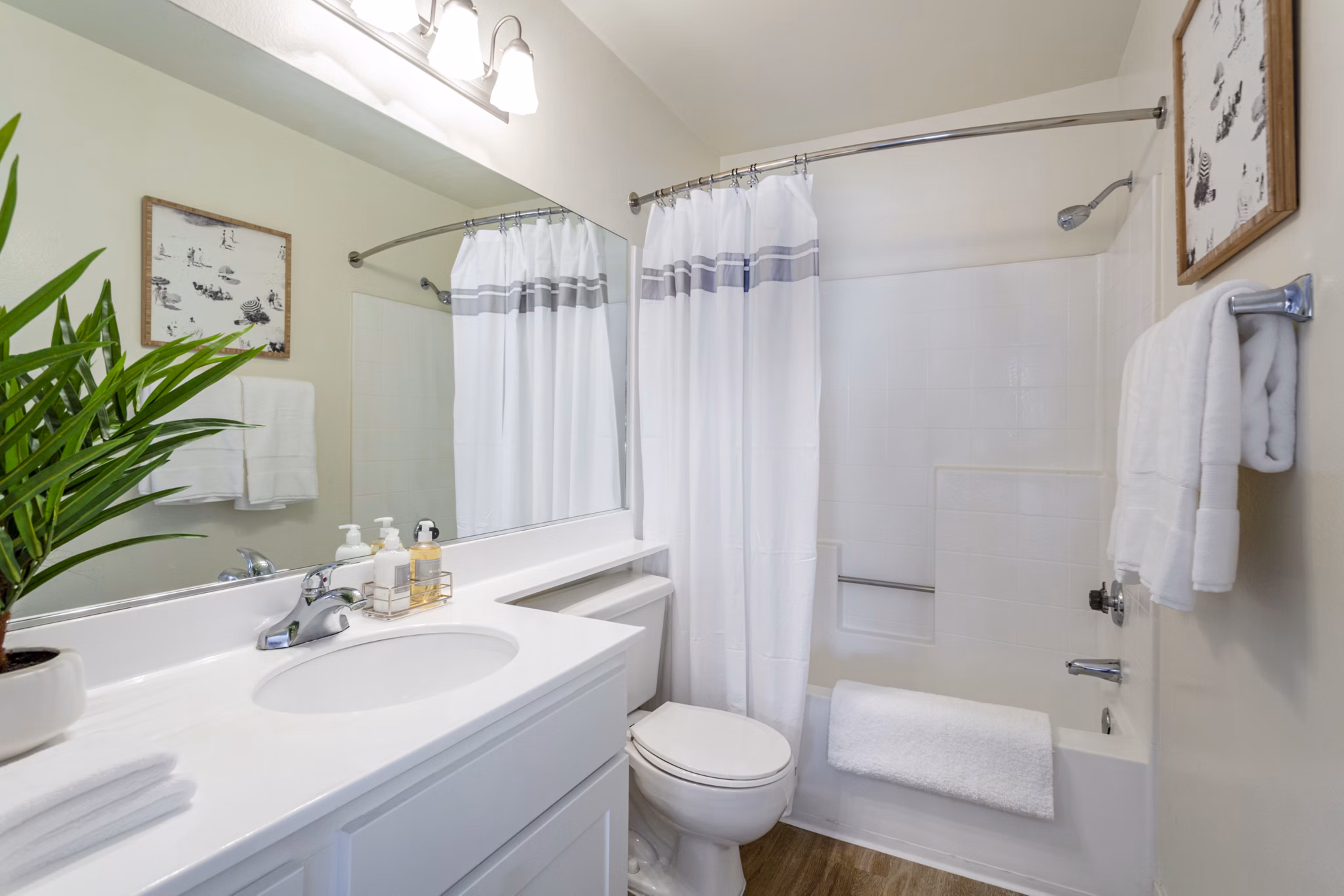 Modern bathroom with sleek fixtures and large mirror at Colony Parc Apartments