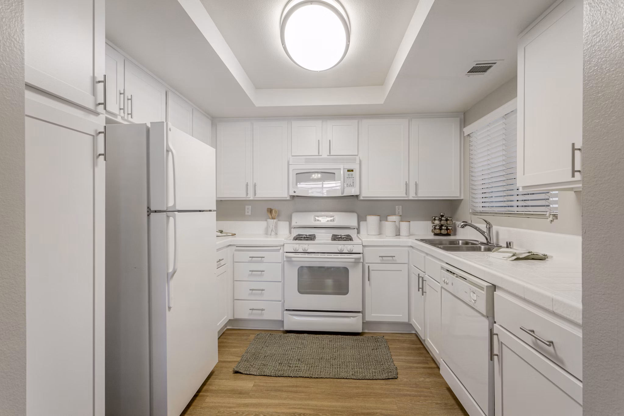 Modern kitchen featuring stainless steel appliances and granite countertops in Colony Parc Apartments
