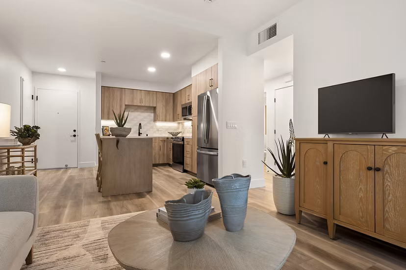 Modern living room with large windows and stylish decor at Colony Parc Apartments