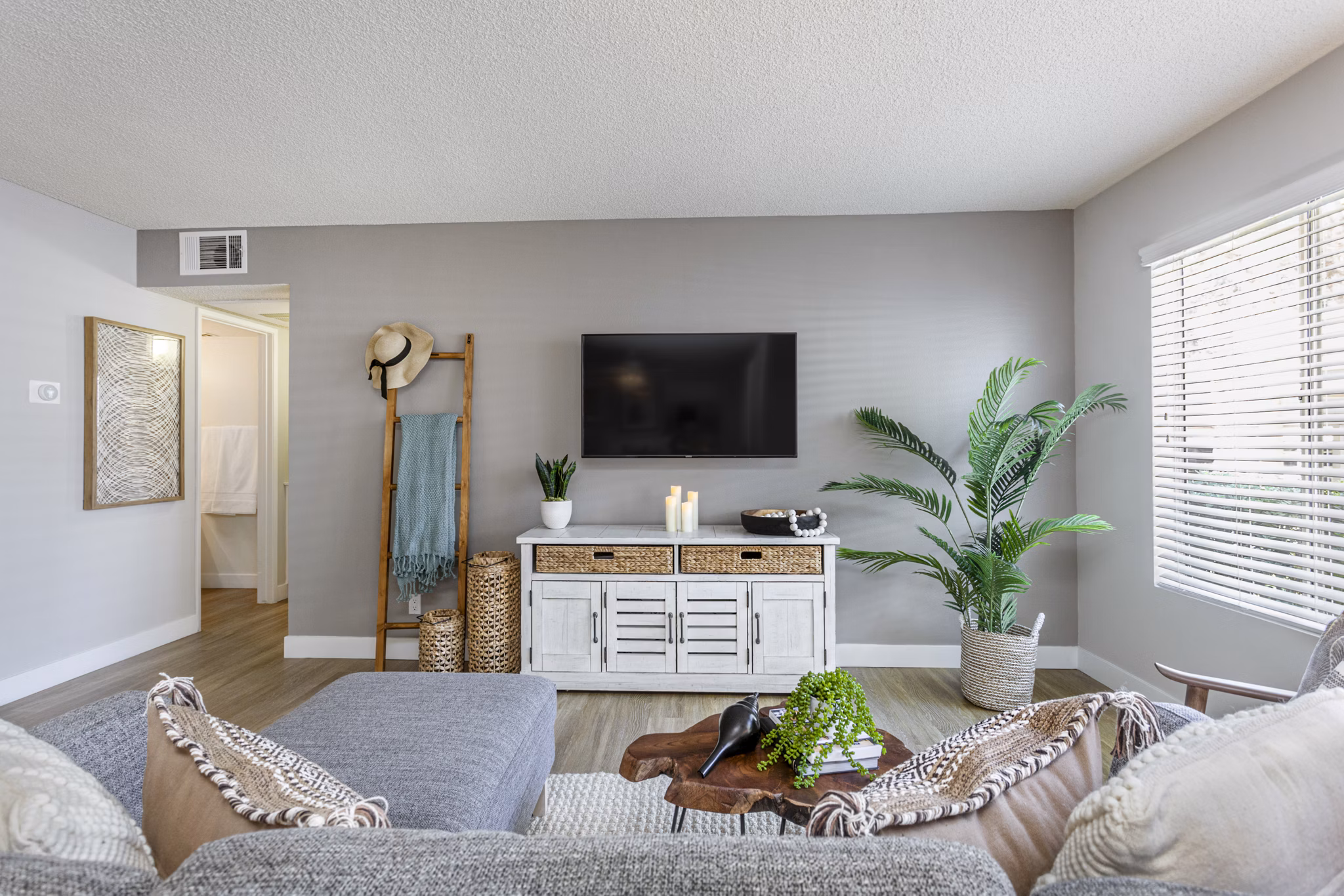 Modern living room with large windows and stylish decor at Colony Parc Apartments