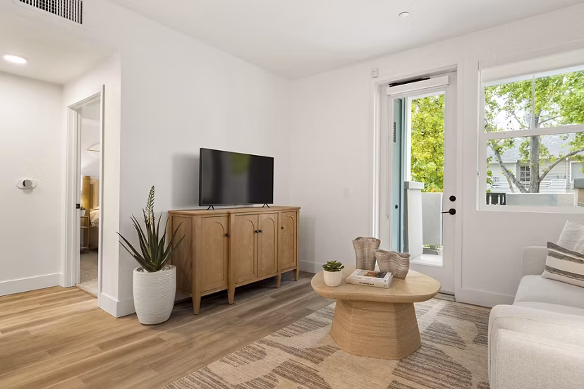 Spacious living room with hardwood floors and modern decor in Colony Parc Apartments