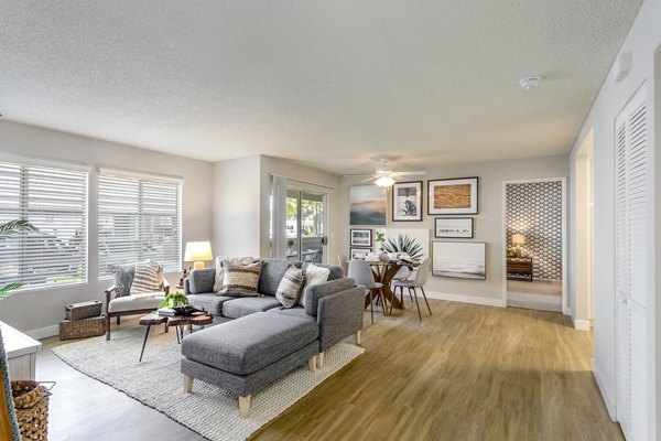 Spacious living room with hardwood floors and modern decor in Colony Parc Apartments