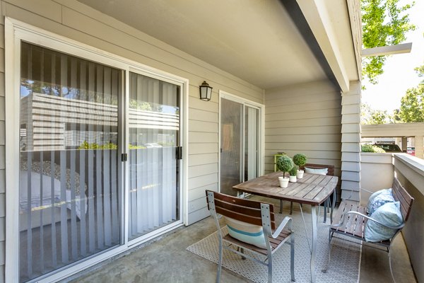 Spacious patio with modern seating at Colony Parc Apartments in a tranquil setting