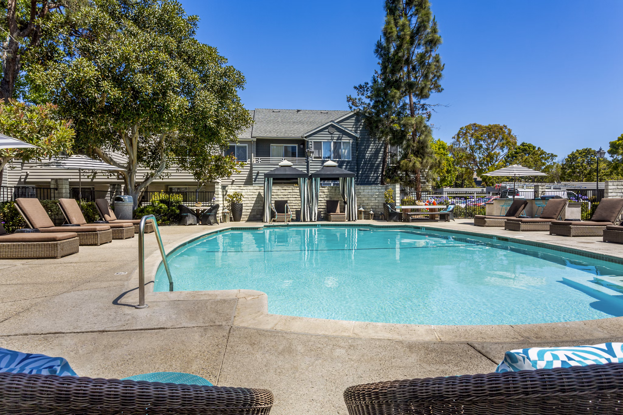 Resort-style pool with lounge chairs at Colony Parc Apartments