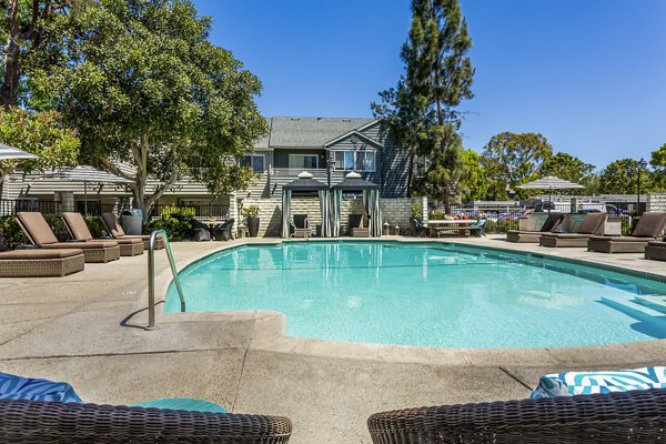 Resort-style pool with lounge chairs at Colony Parc Apartments