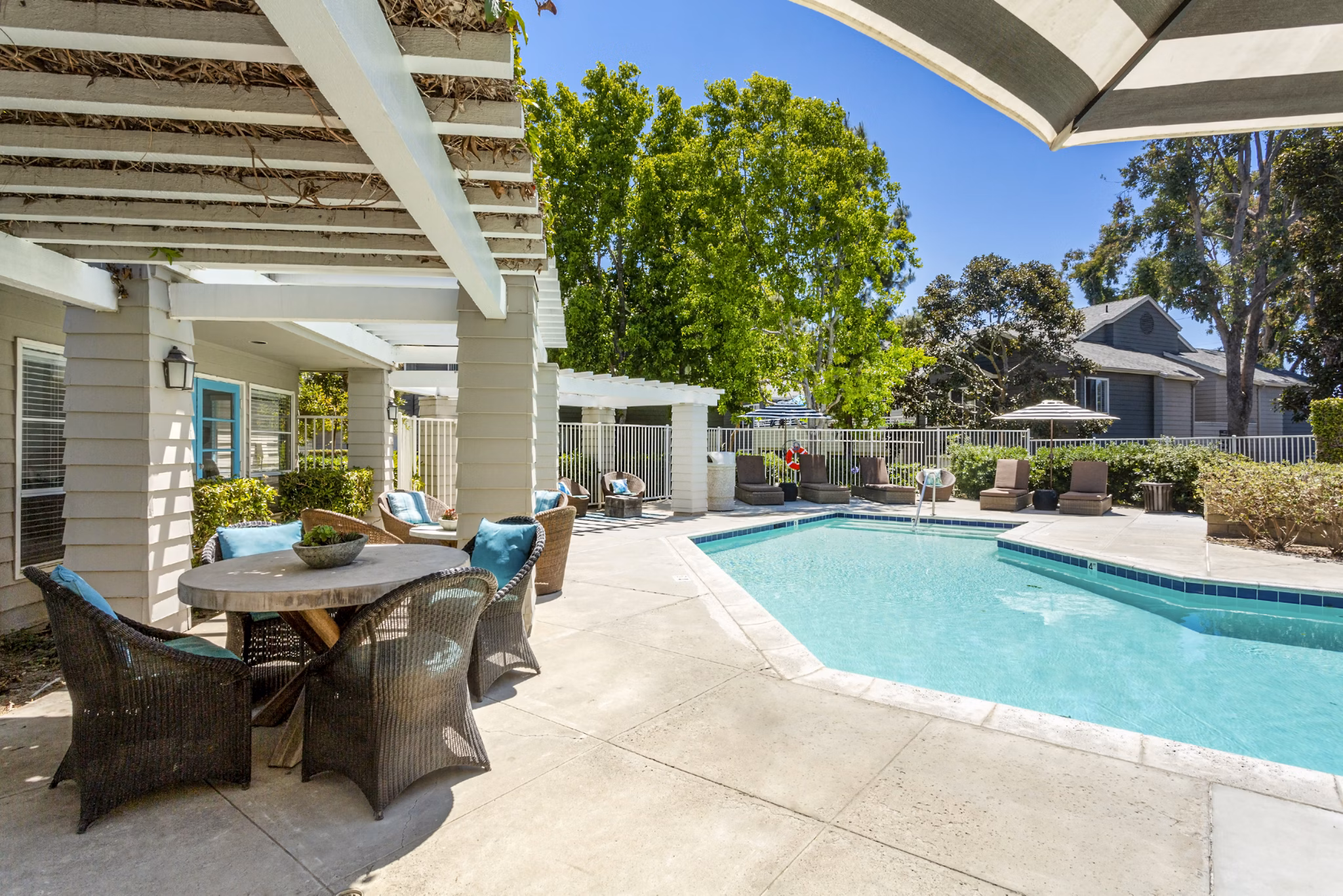 Pool patio with lush landscaping at Colony Parc Apartments in San Luis Obispo, offering luxury outdoor living spaces for relaxation