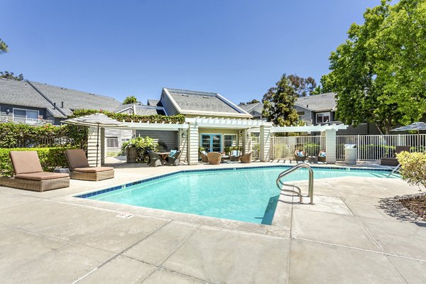 Beautiful outdoor pool with lounger chairs at Colony Parc Apartments, perfect for relaxation and leisure activities in a luxurious setting