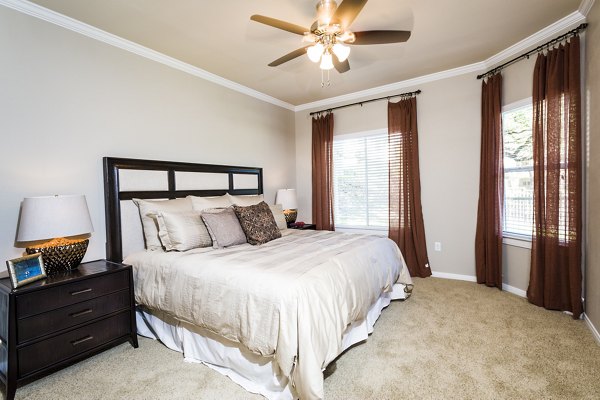 Cozy bedroom with plush bedding at Somerset Townhomes, luxury apartments by Greystar
