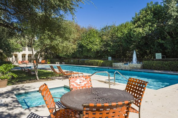 Resort-style pool at Somerset Townhomes with modern lounge chairs and lush landscaping, ideal for luxury apartment living