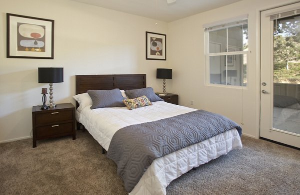 Parc Chateaux Apartments: Elegant bedroom with modern furnishings and large windows