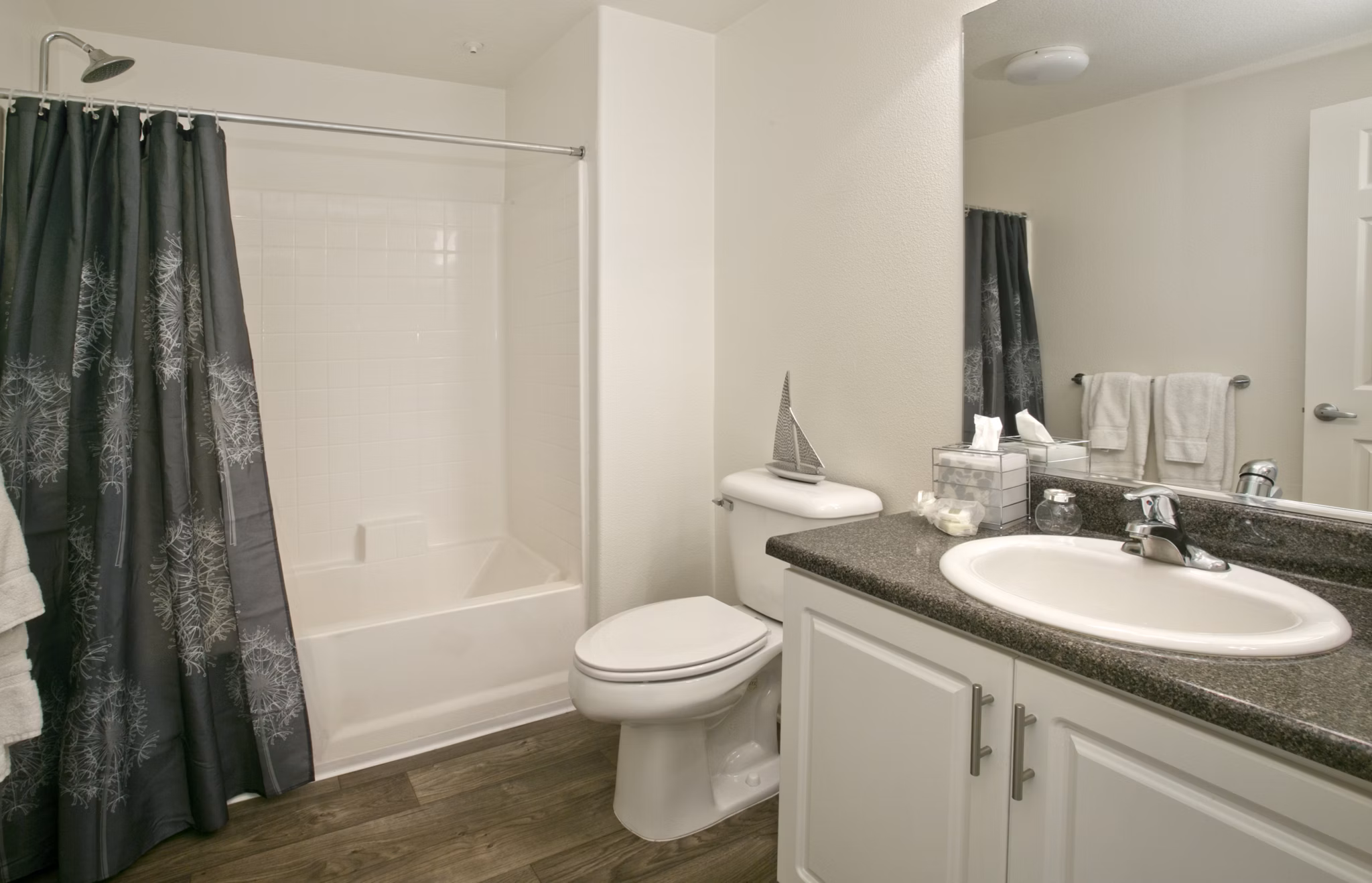 Bathroom with sleek fixtures and marble countertops in Parc Chateaux Apartments