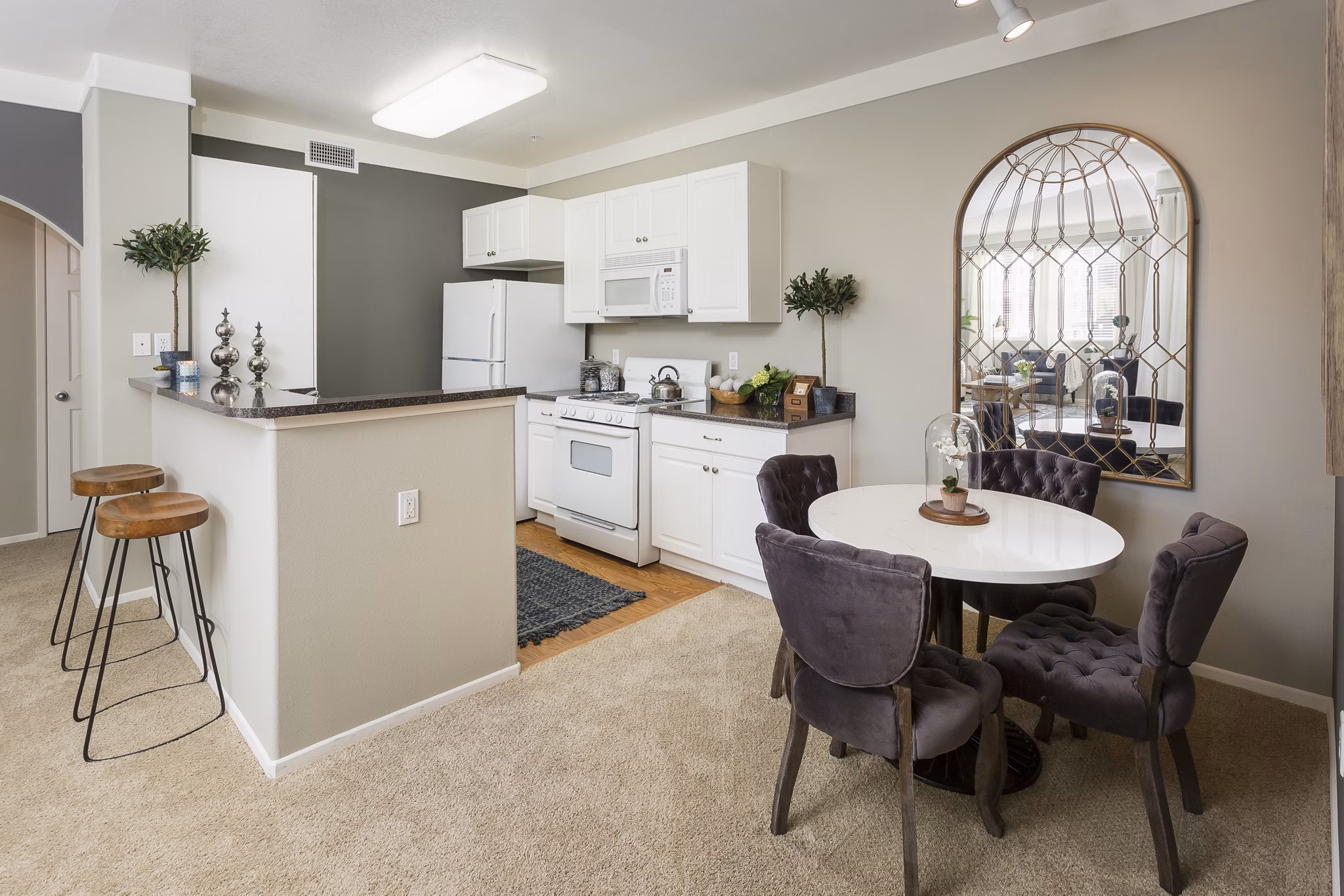 Dining area featuring elegant table and modern chairs at Parc Chateaux Apartments