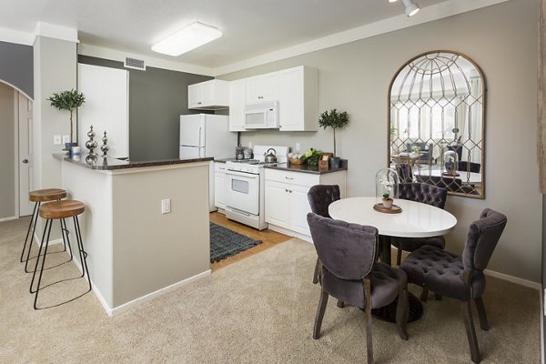 Dining area featuring elegant table and modern chairs at Parc Chateaux Apartments