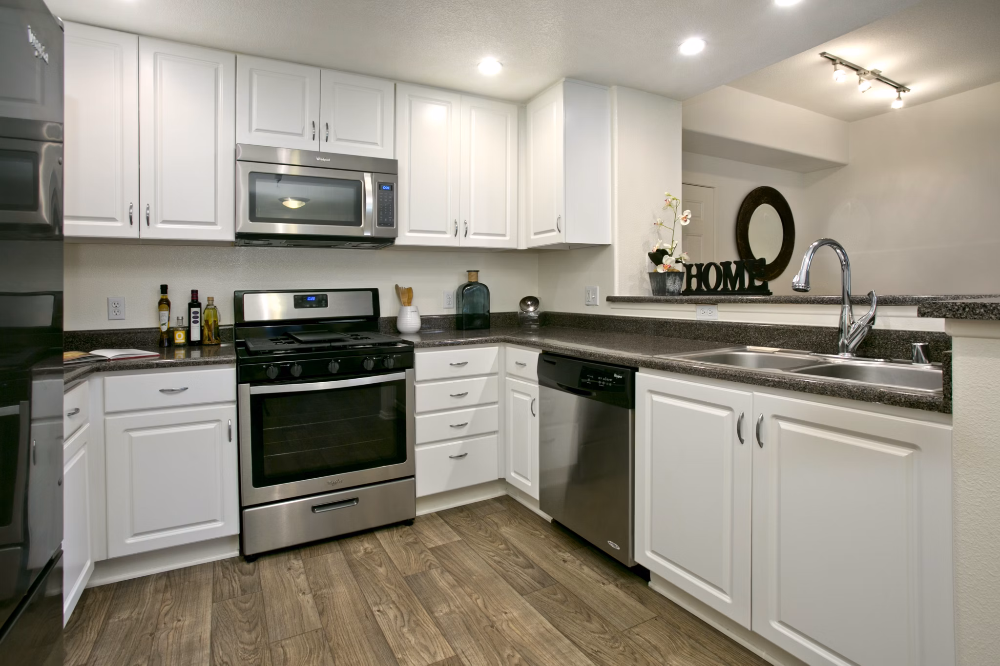 Modern kitchen with stainless steel appliances in Parc Chateaux Apartments, luxury living by Greystar