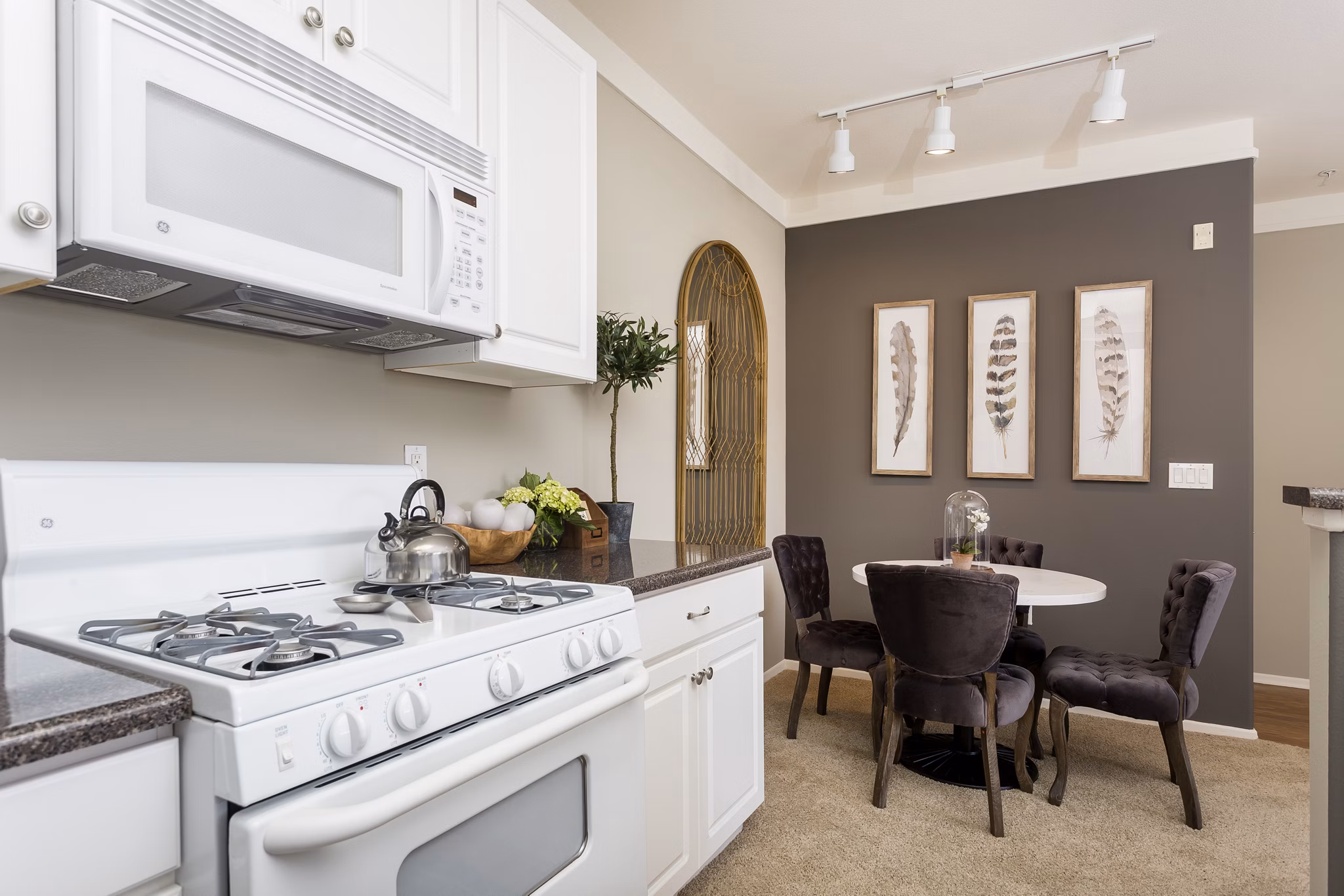 Modern kitchen featuring stainless steel appliances and quartz countertops at Parc Chateaux Apartments in Santa Clarita, CA.