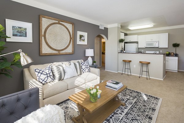 Living room with elegant decor and city view at Parc Chateaux Apartments, a Greystar luxury property