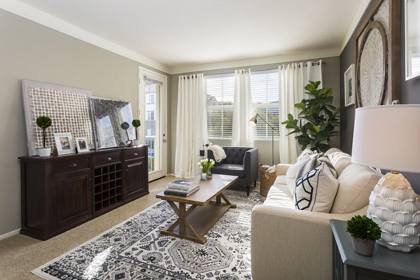 Spacious living room with modern decor in Parc Chateaux Apartments
