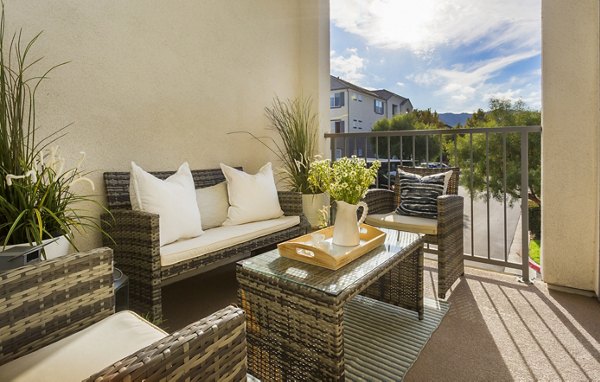 Chic outdoor patio at Parc Chateaux Apartments featuring elegant seating and lush landscaping