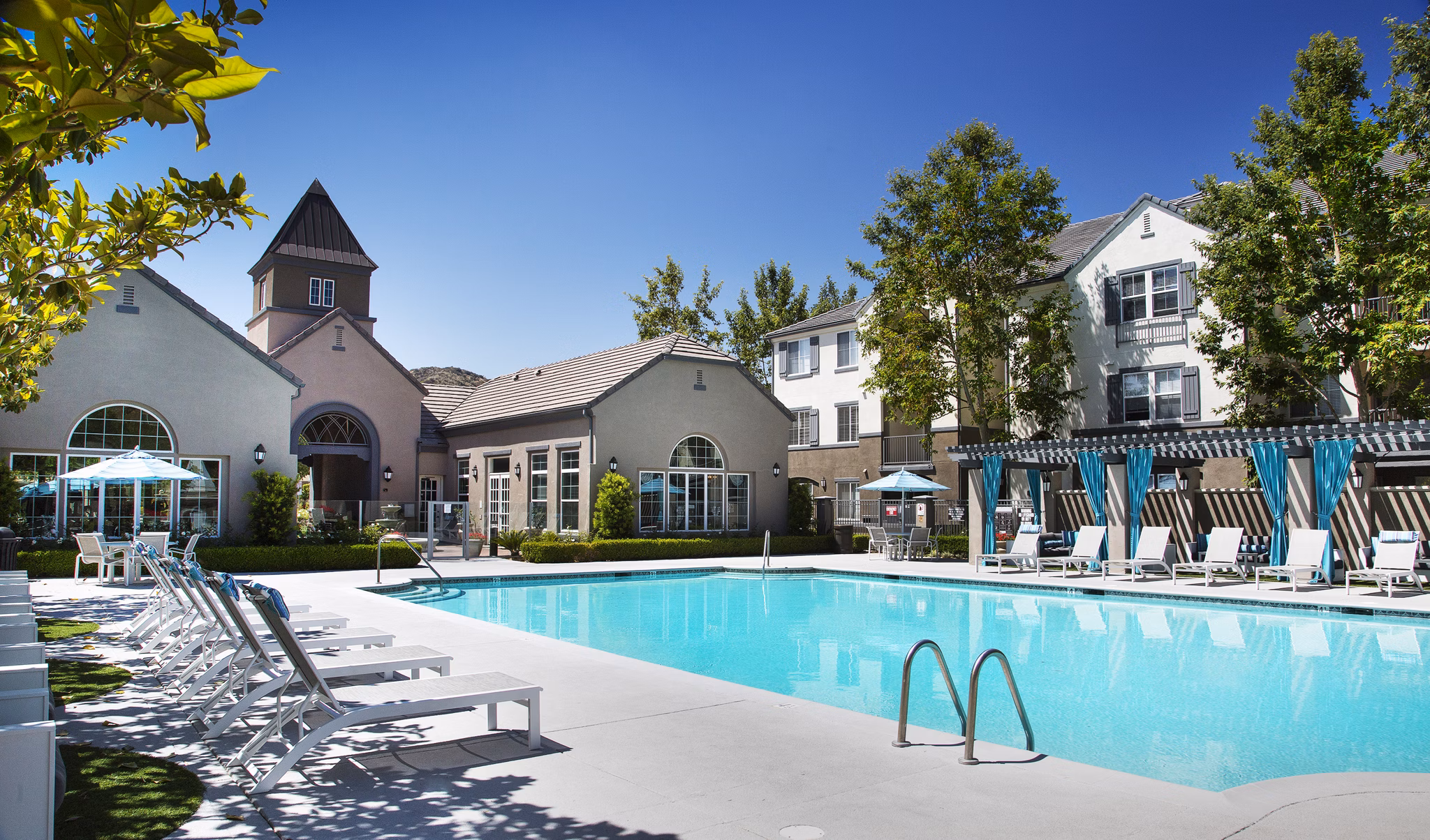 Olympic-sized pool at Parc Chateaux Apartments featuring luxury amenities and relaxation spaces