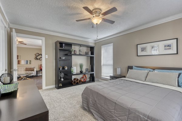 Modern bedroom featuring plush bedding at Stone Chase Apartments, ideal for comfort and relaxation