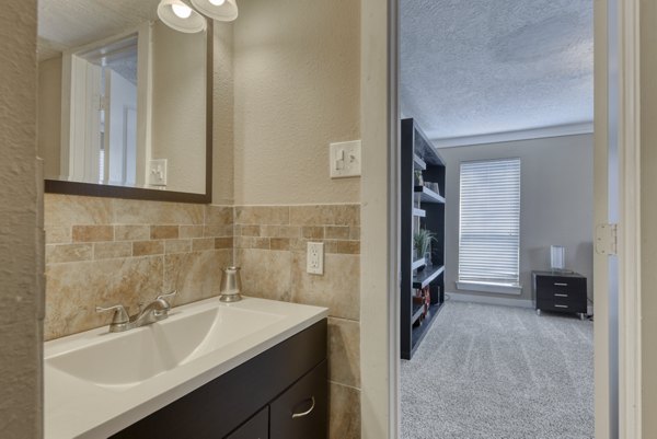 Bathroom with modern fixtures and elegant marble tiling at Stone Chase Apartments in Greystar's luxury community