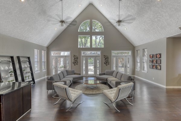 Modern clubhouse with cozy seating and entertainment options at Stone Chase Apartments