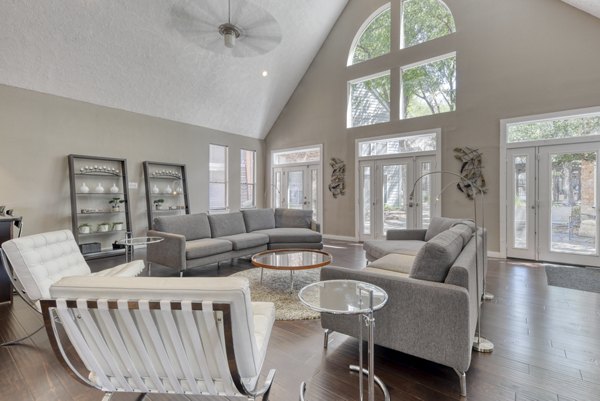 Modern clubhouse with lounge seating and fireplace at Stone Chase Apartments