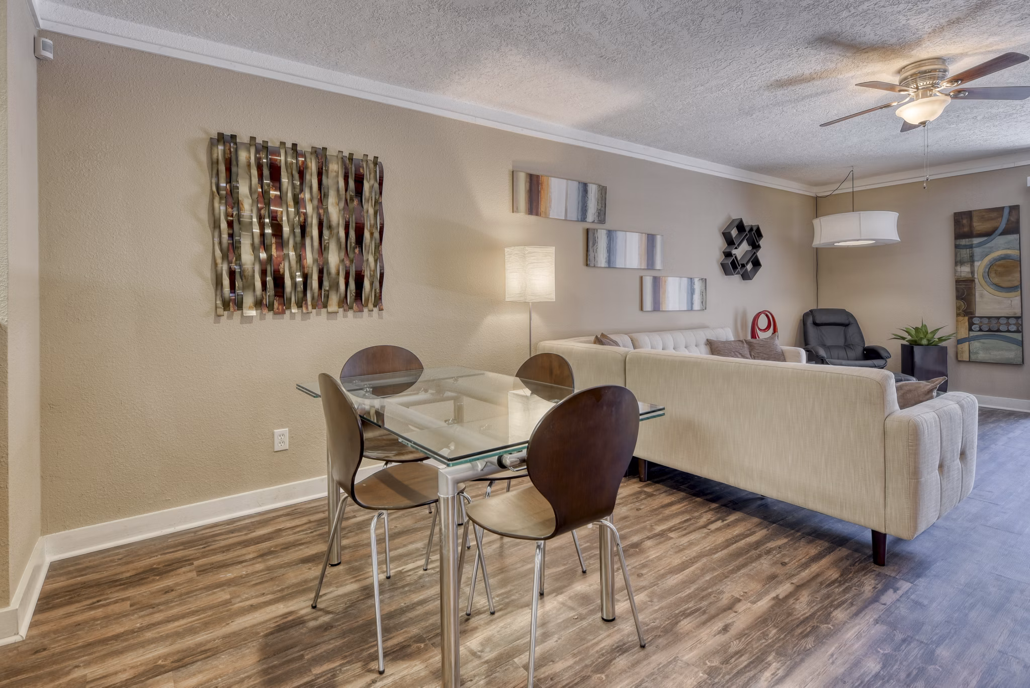 Dining area featuring elegant furniture and modern lighting at Stone Chase Apartments