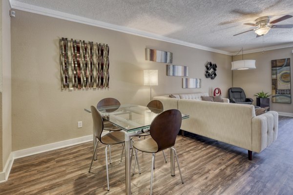 Dining area featuring elegant furniture and modern lighting at Stone Chase Apartments