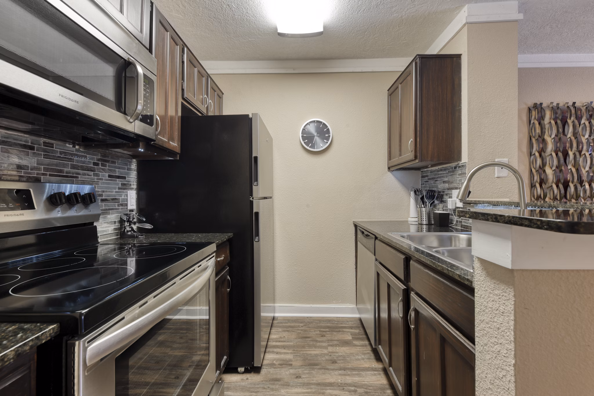 Modern kitchen with stainless steel appliances at Stone Chase Apartments