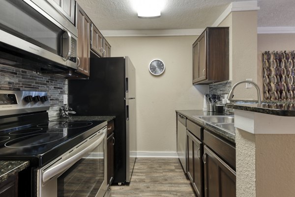 Modern kitchen with stainless steel appliances at Stone Chase Apartments