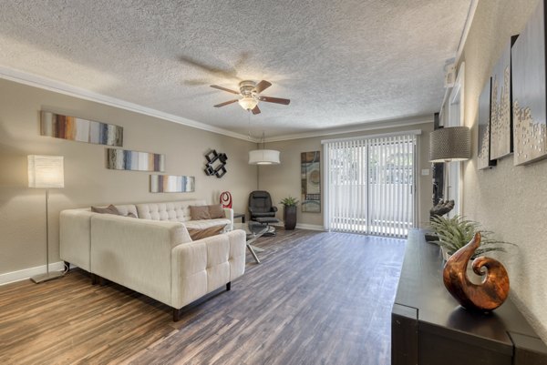 Modern living room with stylish decor at Stone Chase Apartments featuring sleek furnishings and ample natural light