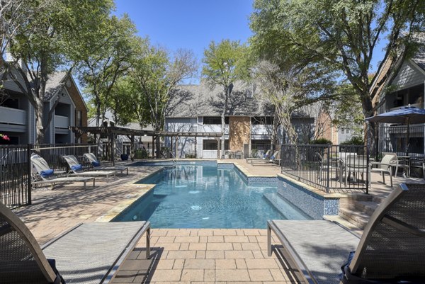 Resort-style pool with lounge chairs at Stone Chase Apartments, perfect for relaxation and recreation