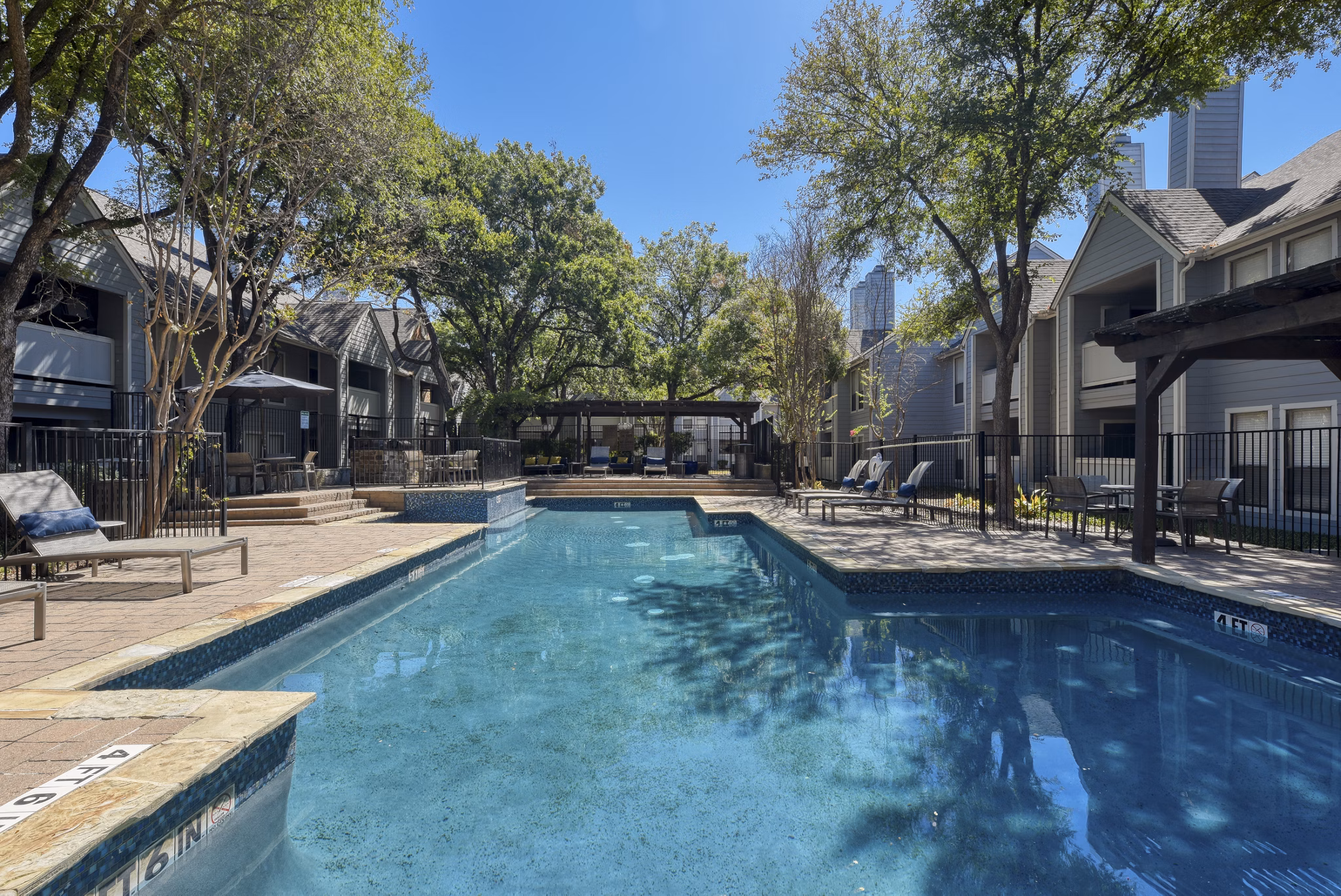 Crystal-clear community pool at Stone Chase Apartments offering a relaxing oasis for residents