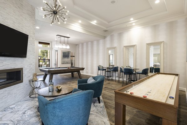 Clubhouse game room with billiards and seating area at Mission Grove Park Apartments